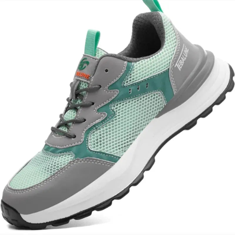 Green low-top work shoe with plastic toe cap, mesh panels, and slip-on design on a TPU sole.