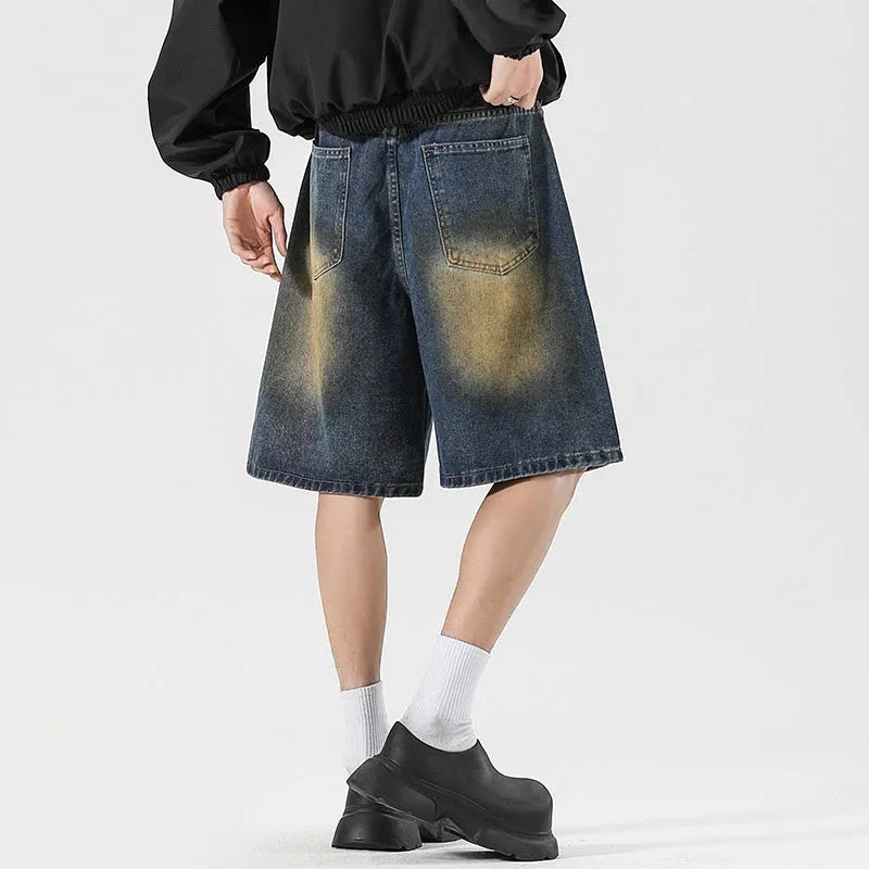 Retro blue loose-fit distressed denim jeans on a hanger, showing ripped detailing.