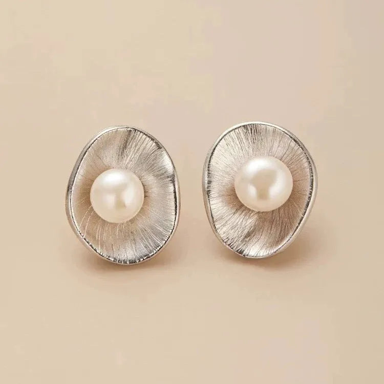 Gold-coloured geometric pearl stud earrings made from sterling silver with electroplated finish