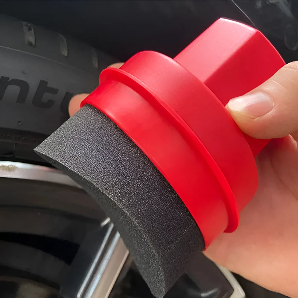 Black and red tire polishing sponge brushes with PP handles and lids on a garage workbench.