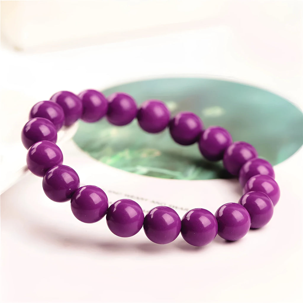 Purple Mica crystal bracelet with polished beads in a single circle design on a wrist.