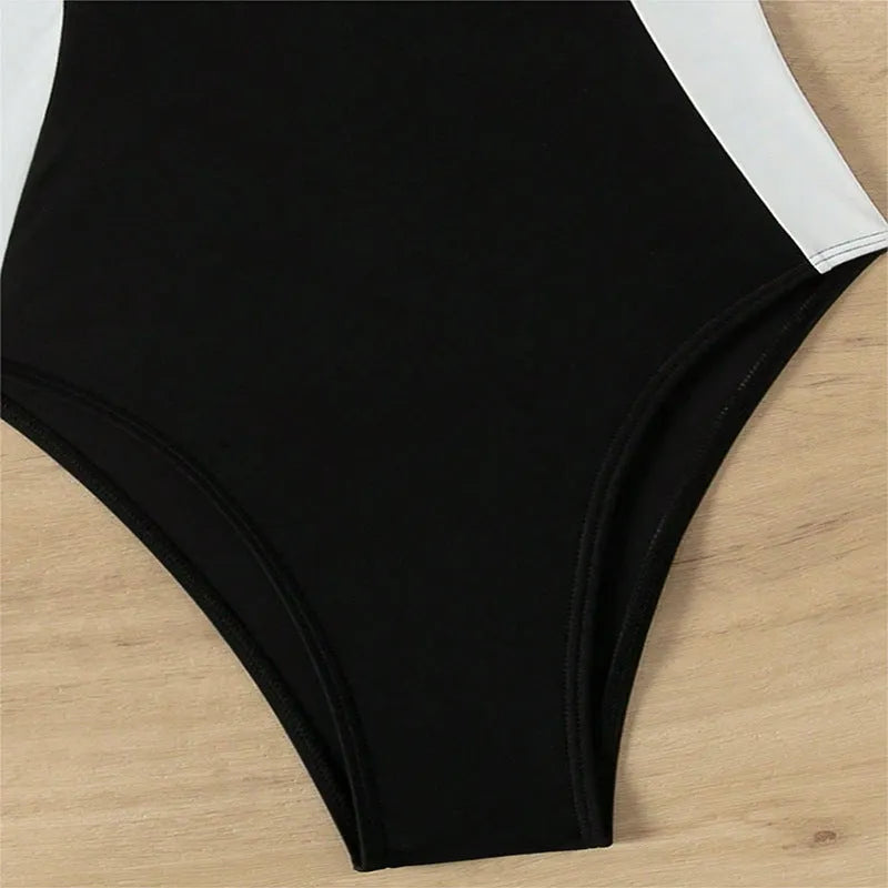 Women's black and white pearl spaghetti strap one-piece swimsuit with sleeveless slimming design.
