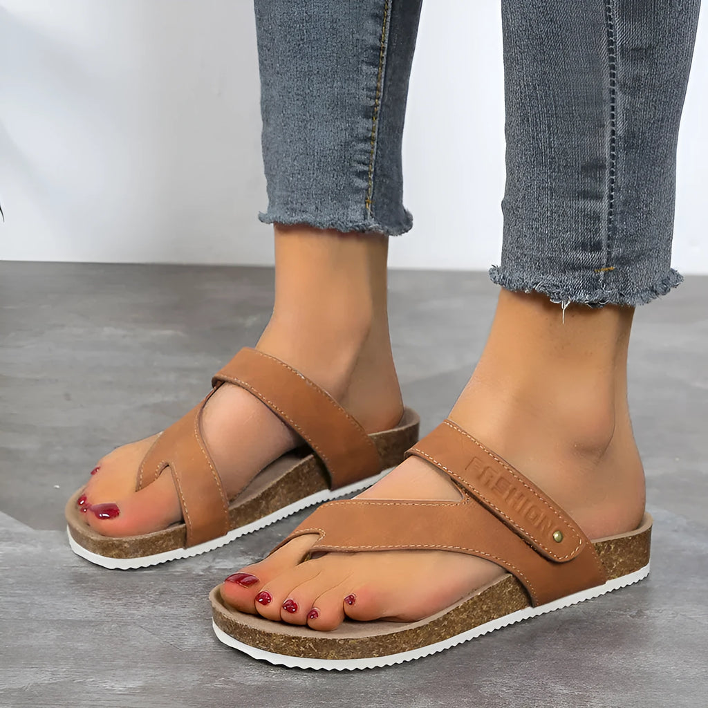 A pair of women's thick-soled flip-flops with a flat toe ring design in a solid colour.