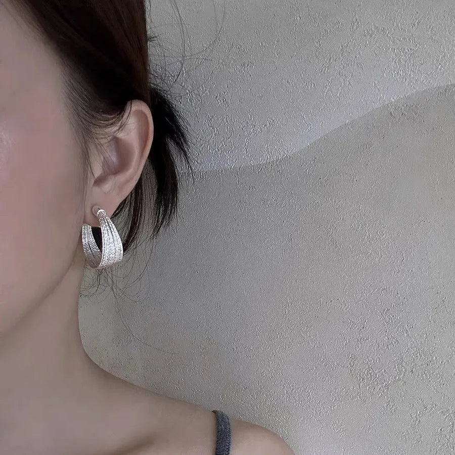 Geometric multi-layer copper earrings with silver or gold electroplated finish, showing stud and clip options