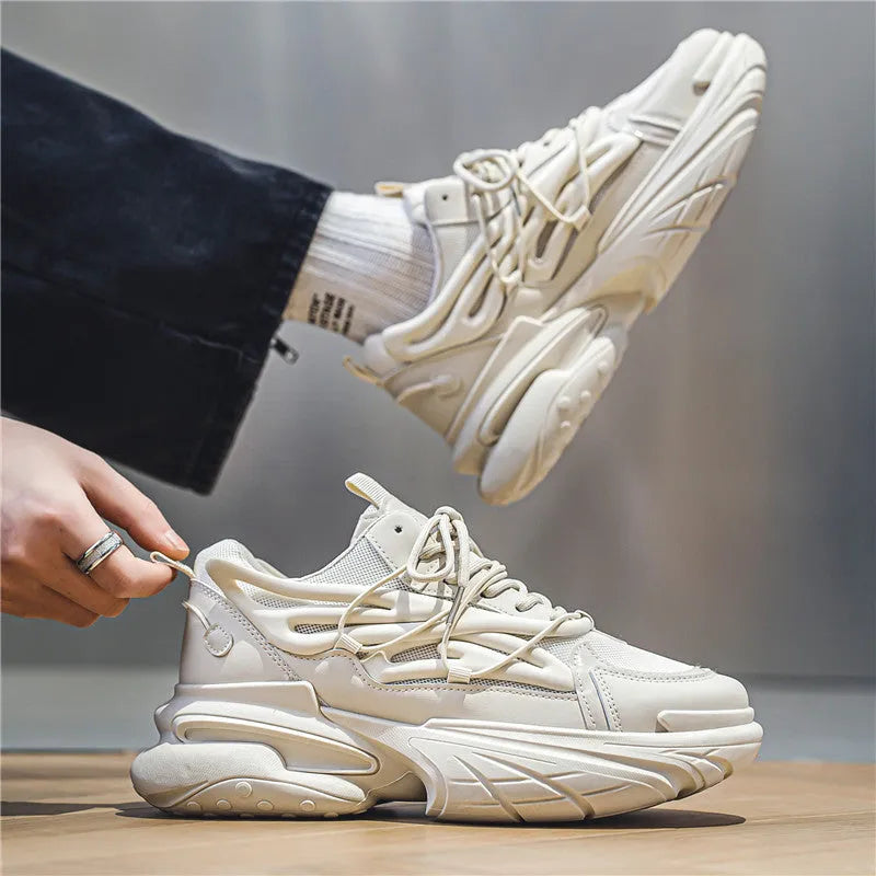Men's beige low-top lace-up sneaker with mesh upper and platform rubber sole.