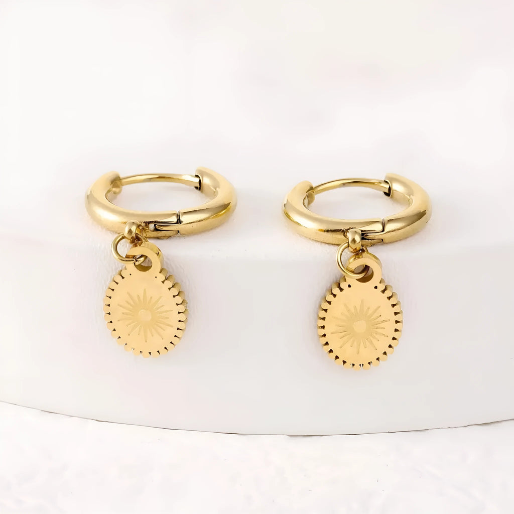 Stainless steel geometric earrings with oval accents on white background