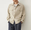 Men's light sand rice long sleeve collared shirt with collage stitch detailing on front.