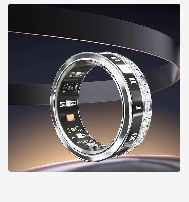 Silver and gold smart ring with diamond inlay on finger, showing charging cable and box.