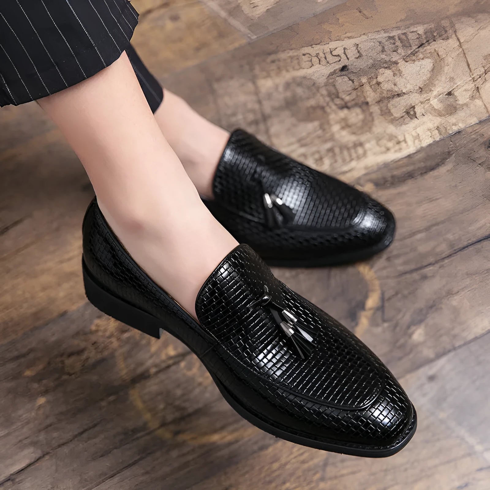 Men's black pointed toe slip-on business shoes with tassel detail on artificial PU upper