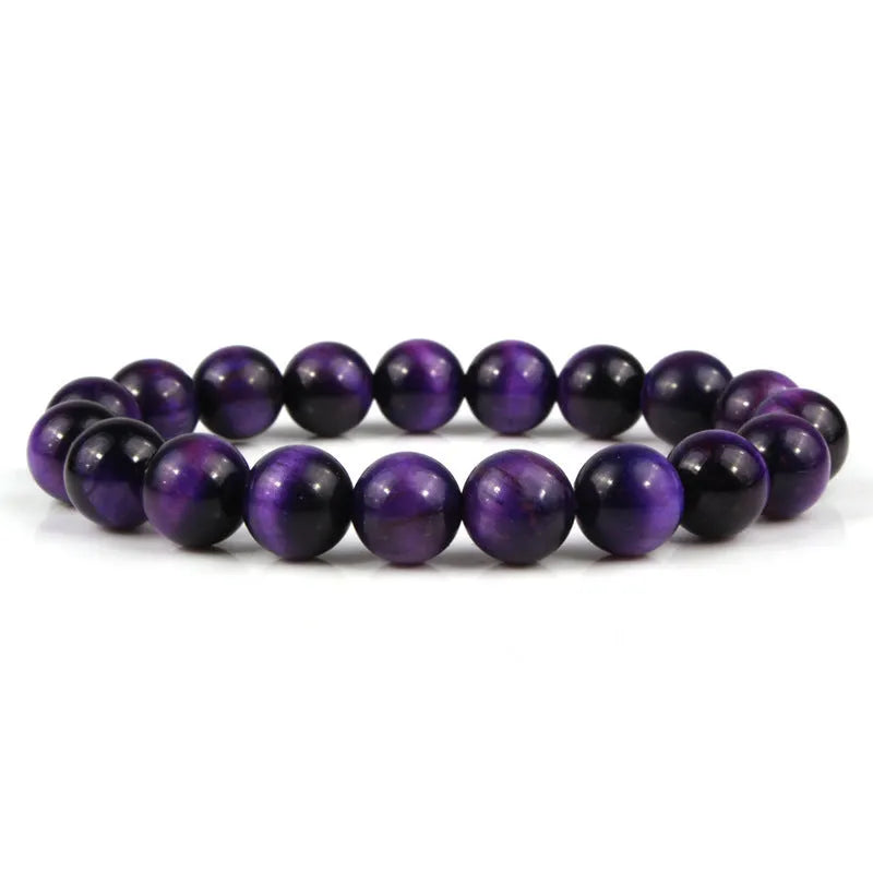 Natural tigereye crystal beaded bracelet with round beads, shown in a selection of colours and sizes on a wrist.