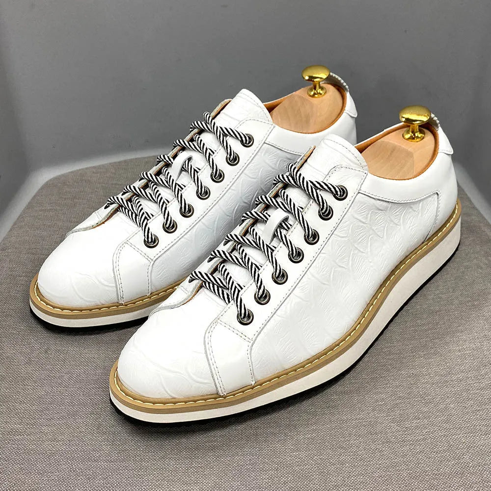 Men's handmade low-top shoes with embossed pattern detail and front laces.
