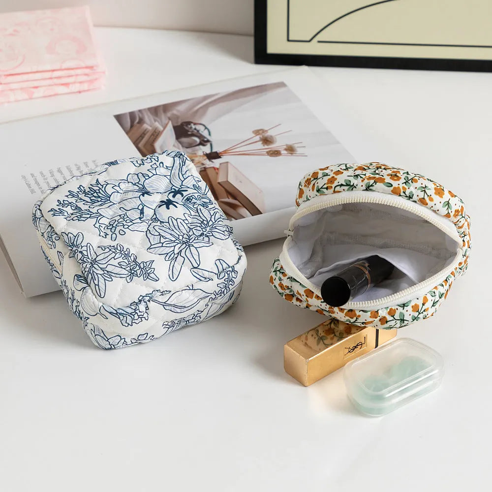 Polyester key storage wallet with floral or cherry print and sewing thread detail.
