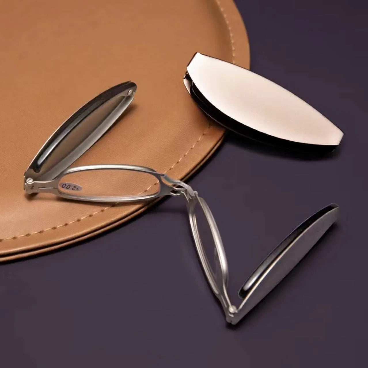 Folding presbyopic glasses in black retro frame showing ring detail and folded position