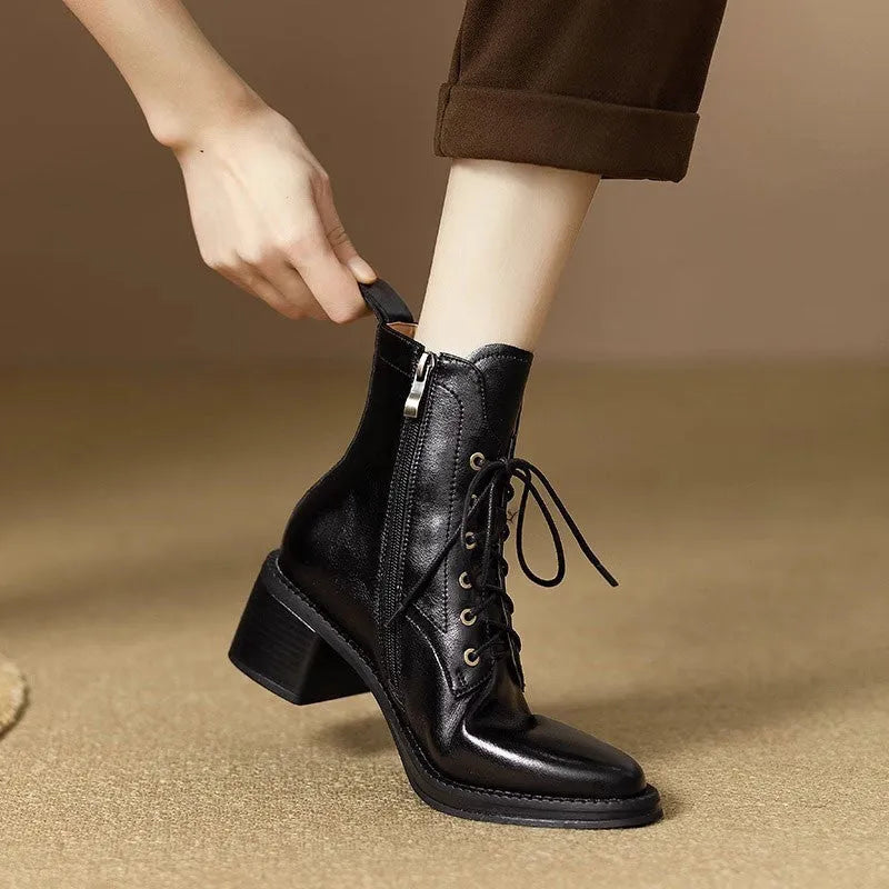 Women's black pointed-toe ankle boots with block heel and short shaft design