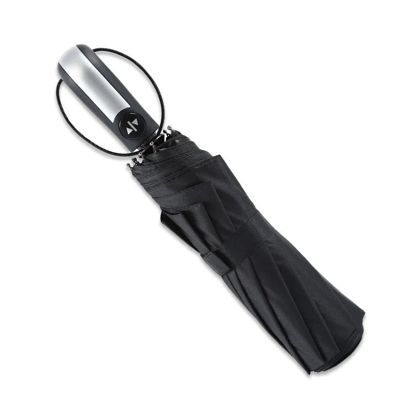 Black triple folding automatic business umbrella with steel ribs and a rubber handle.