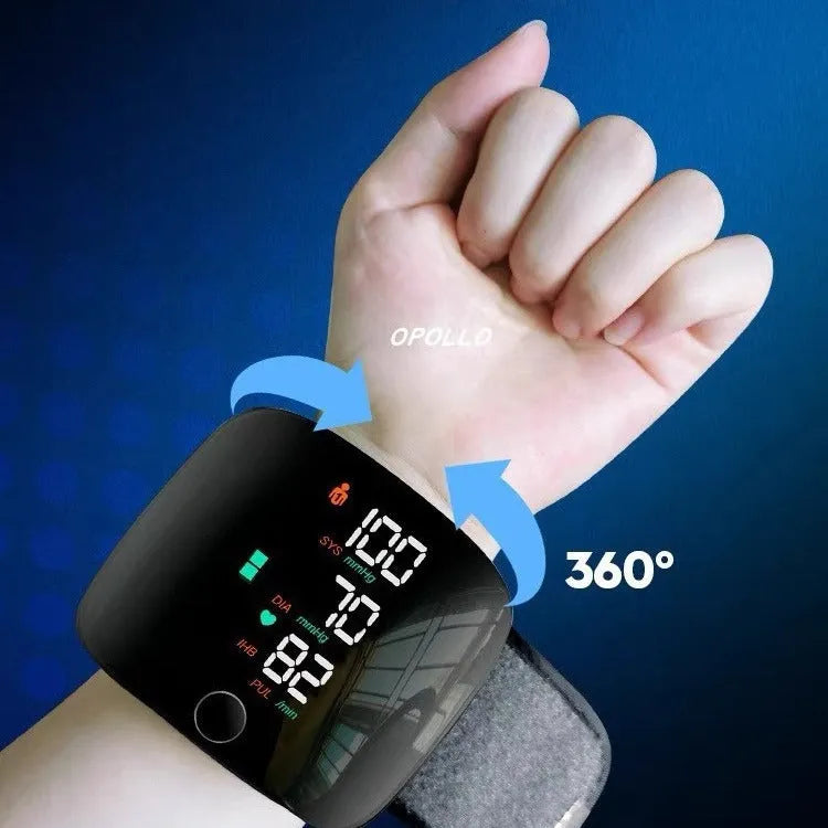 Black wrist blood pressure monitor with digital display and USB charging cable