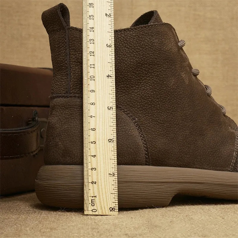 Grey genuine leather Martin boots with lace-up front and wedge heel on a plain background.