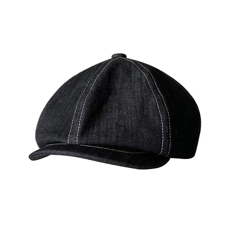 Black cotton retro-style beret for men and women on a plain background.