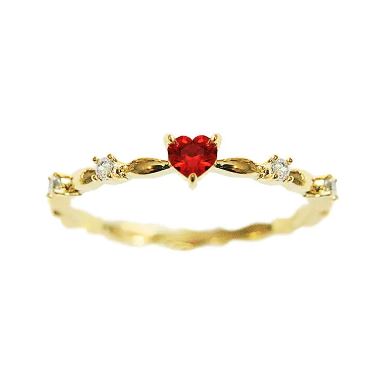 Gold or silver electroplated peach heart fashion ring with zircon stone accents on a copper band.
