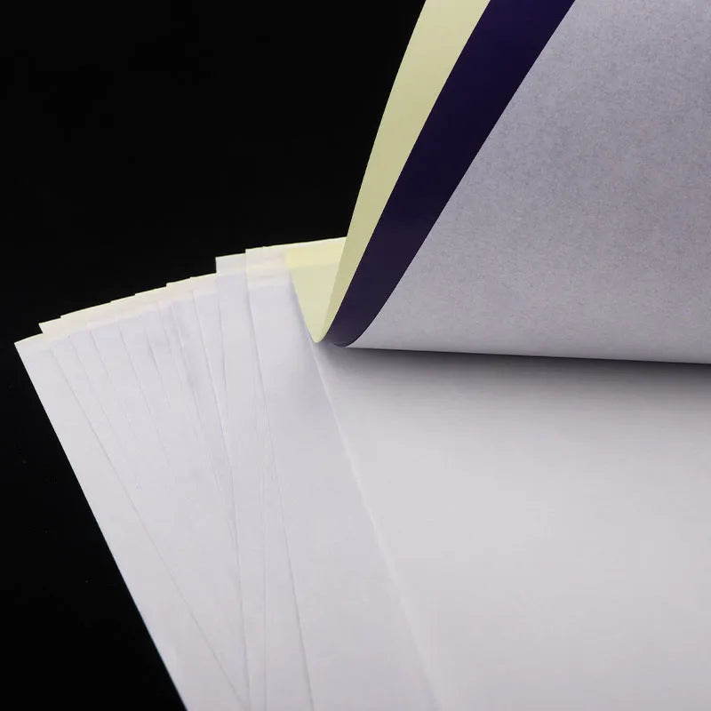 Stack of A4 tattoo transfer paper sheets showing quadruple copy layers for stencil making