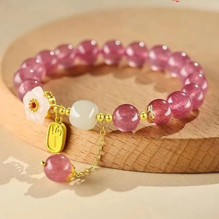 Handmade strawberry quartz crystal bracelet for women showing natural bead details on wrist