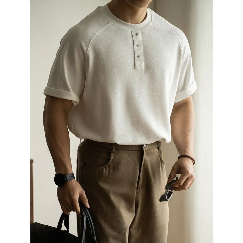 Casual loose-fitting pullover top with raglan sleeves in a terry texture fabric.