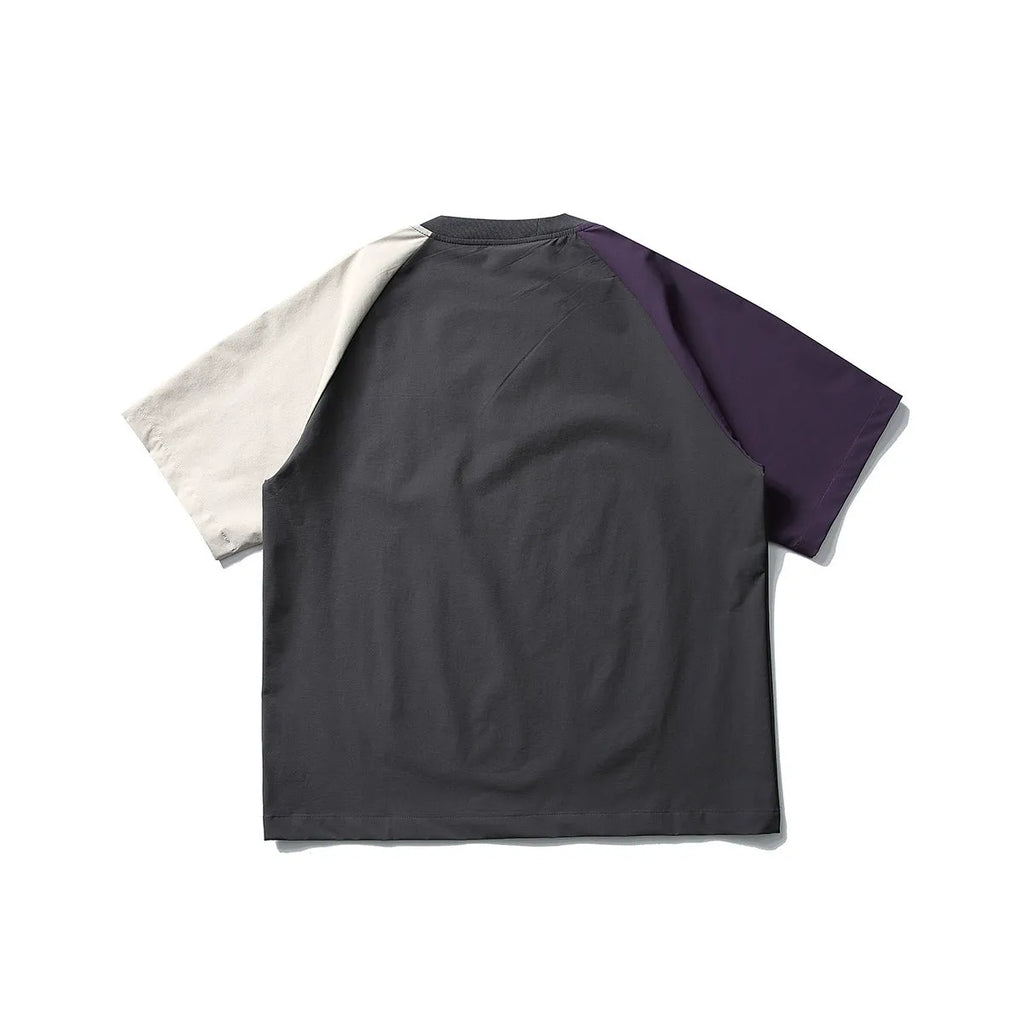 Dark grey loose fit quick-dry t-shirt with contrast raglan sleeves on a hanger.