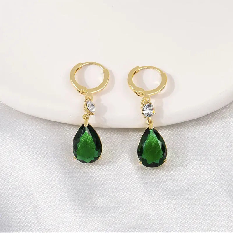 Green geometric teardrop alloy earrings with drop design on display