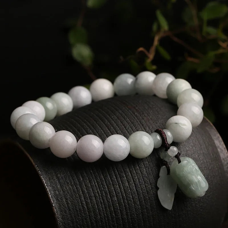 Natural jade bracelet with geometric pendant and hanging charms including Maitreya Buddha, gourd, and double apple designs