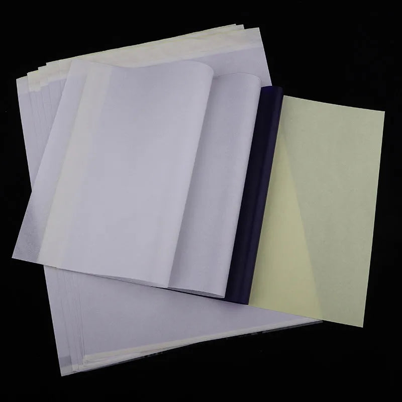 Stack of A4 tattoo transfer paper sheets showing quadruple copy layers for stencil making