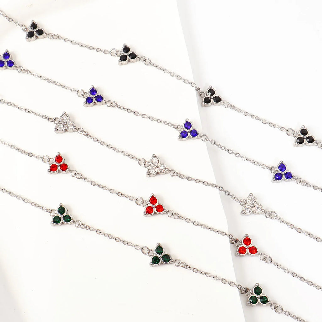 Geometric triangle bracelet for women in stainless steel with coloured zircon stones.