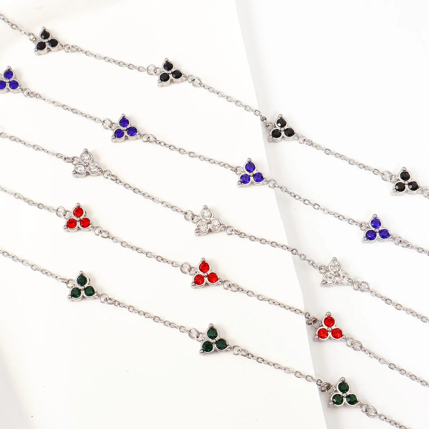 Geometric triangle bracelet for women in stainless steel with coloured zircon stones.