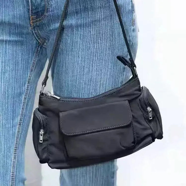 Simple black lightweight double pocket shoulder bag made of PU with side line detail.