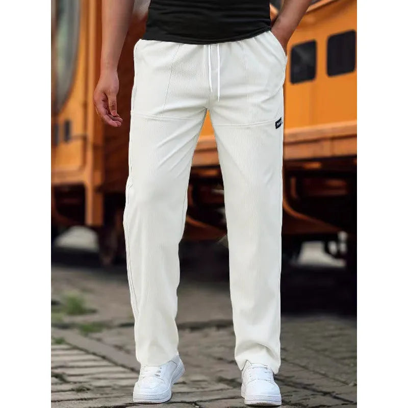 Men's polyester trousers in light grey, shown flat, with a size label indicating S-XXXL range.