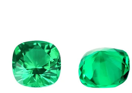 Loose cultivated emerald gemstone cabochon in Columbia green showing polished round and Asscher cut shapes.