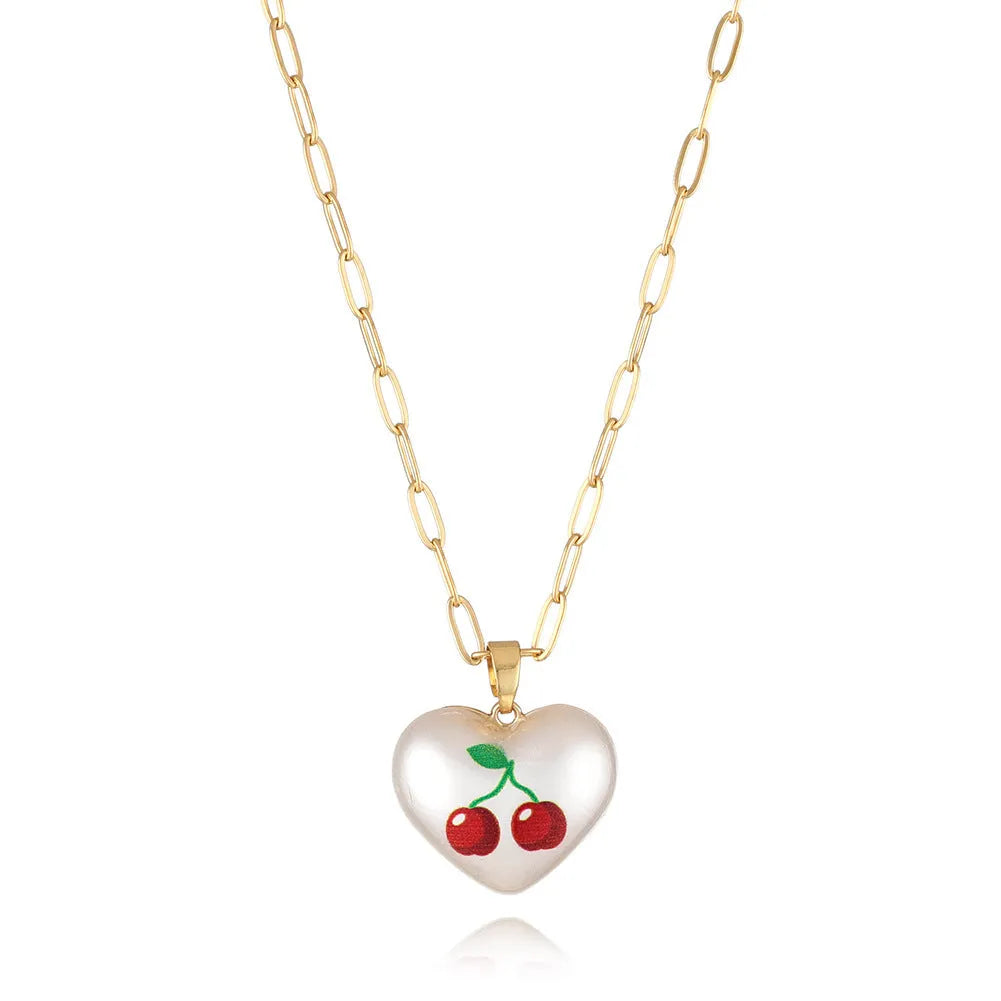 Adjustable heart necklace showing geometric fruit pendants: apple, pineapple, strawberry, cherry, and pear.