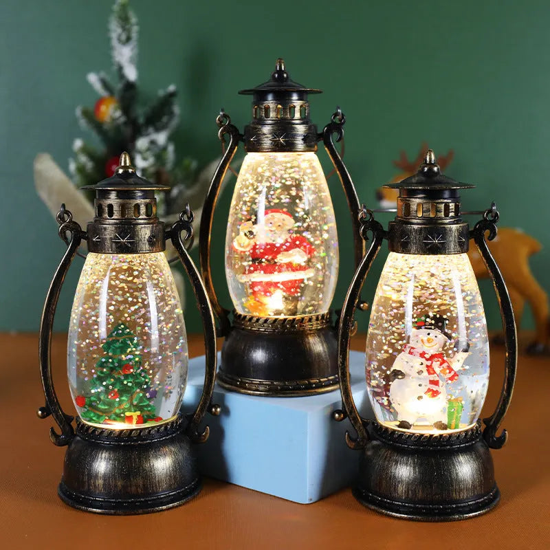 Plastic crystal ball LED oil lamp Christmas ornament with internal snowman figurine on a desktop.