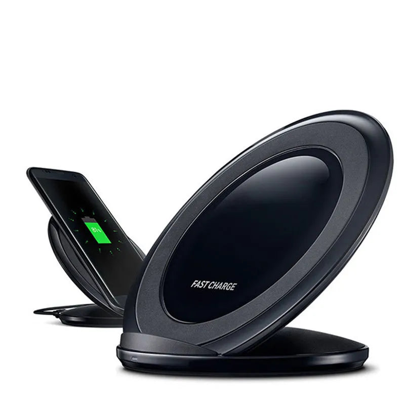A black or white wireless charging pad for a Samsung Galaxy Note Edge mobile phone on a desk.