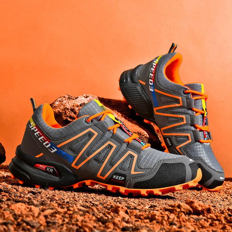 Men's plus size grey orange casual running shoes with low-top design and rubber sole.