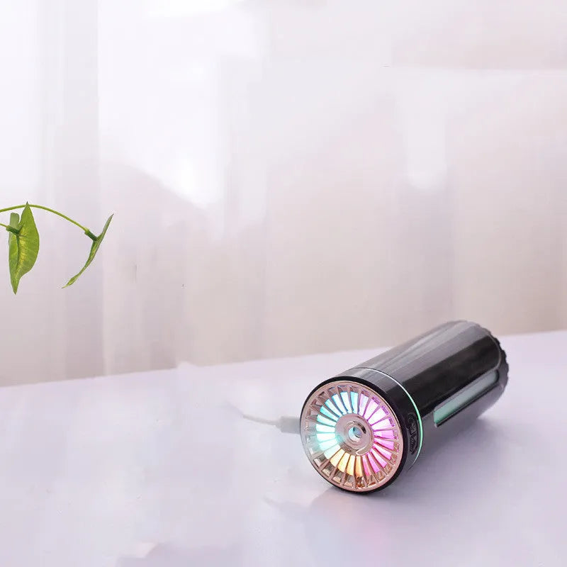 Black portable USB humidifier with colourful LED lights, shown next to a USB cable, suitable for car cup holders.