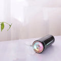 Black portable USB humidifier with colourful LED lights, shown next to a USB cable, suitable for car cup holders.