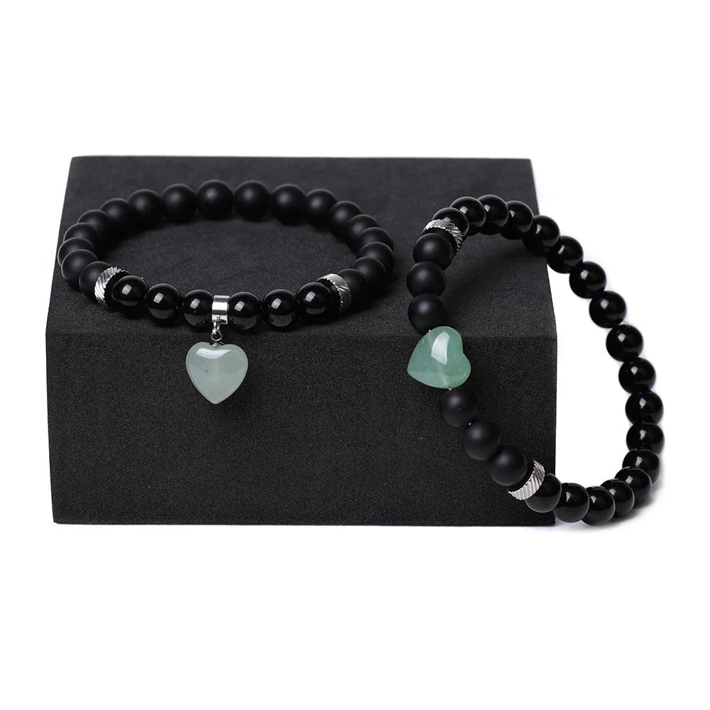 Polished natural stone couple heart bracelets in obsidian, agate, tigereye, crystal, aventurine, topaz, opal colours.