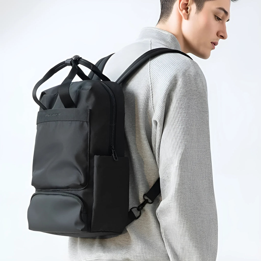Black lightweight Oxford cloth computer backpack showing internal organisational compartments
