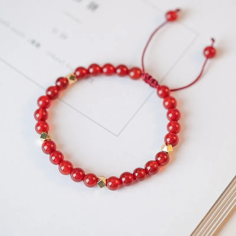 Hand-woven red agate bracelet with diamond-shaped beads and ethnic woven patterns