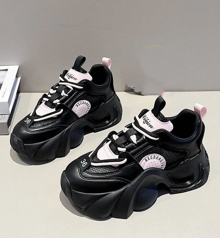 Women's pink casual sneakers with cross shoulder straps and a thick sole.