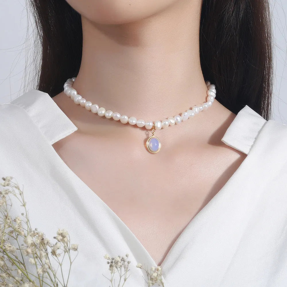 Geometric silver pendant pearl necklace with adjustable chain on white background