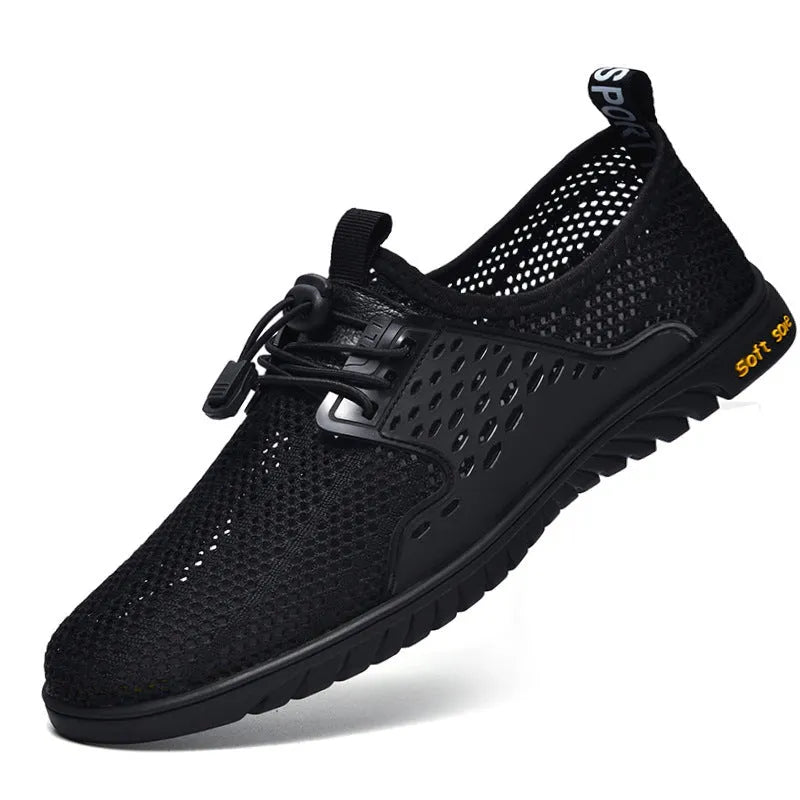 Men's black casual sports shoes with mesh upper and elastic band, displayed from side view