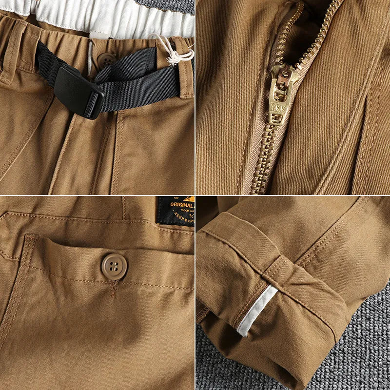 Man wearing khaki cotton work trousers with a flat front and mid-rise waist.
