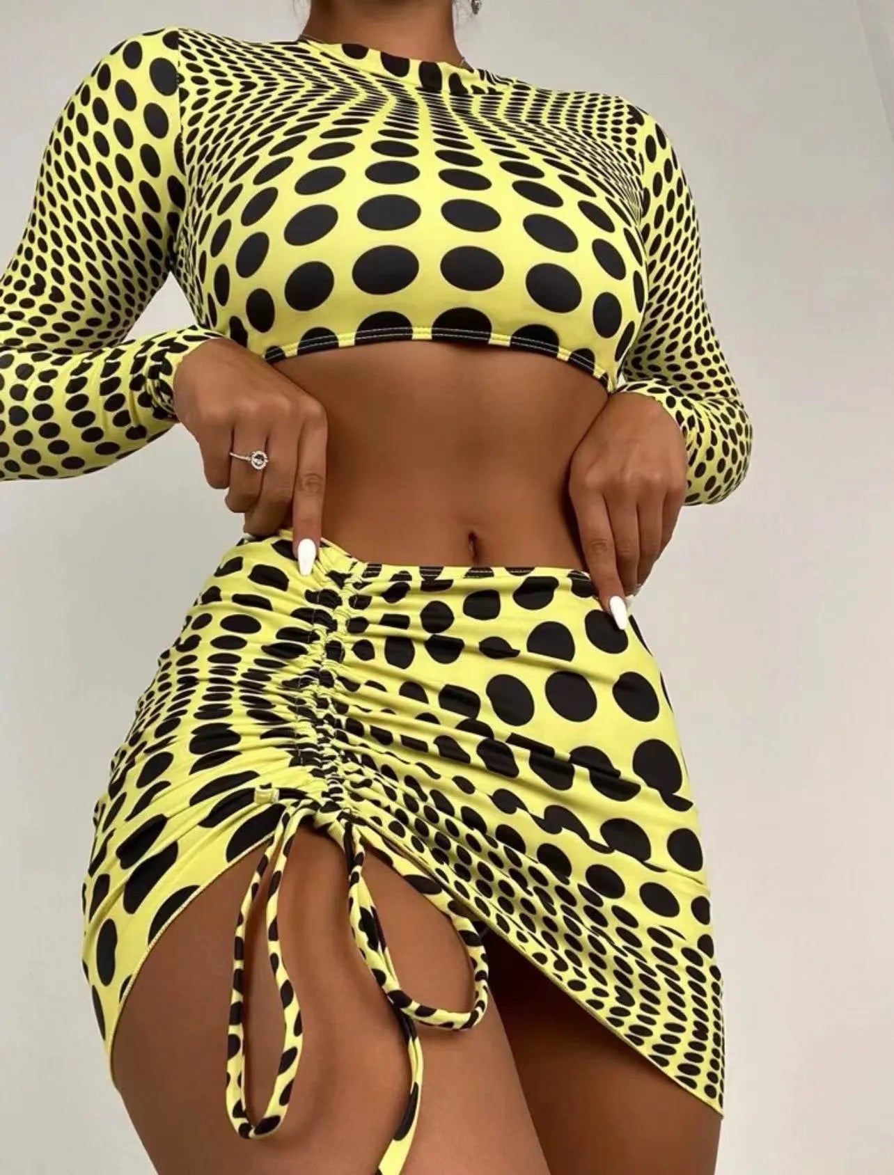 Women's green polka dot swimsuit three-piece set showing top, skirt and bra components