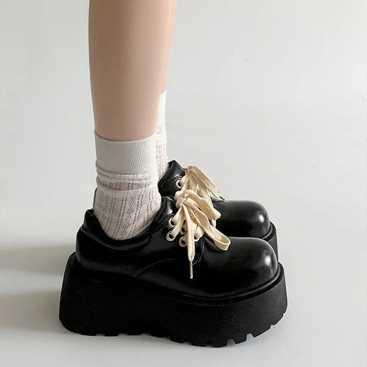 Women's matte black retro ankle boots with a thick rubber sole and buckle fastening on the side.